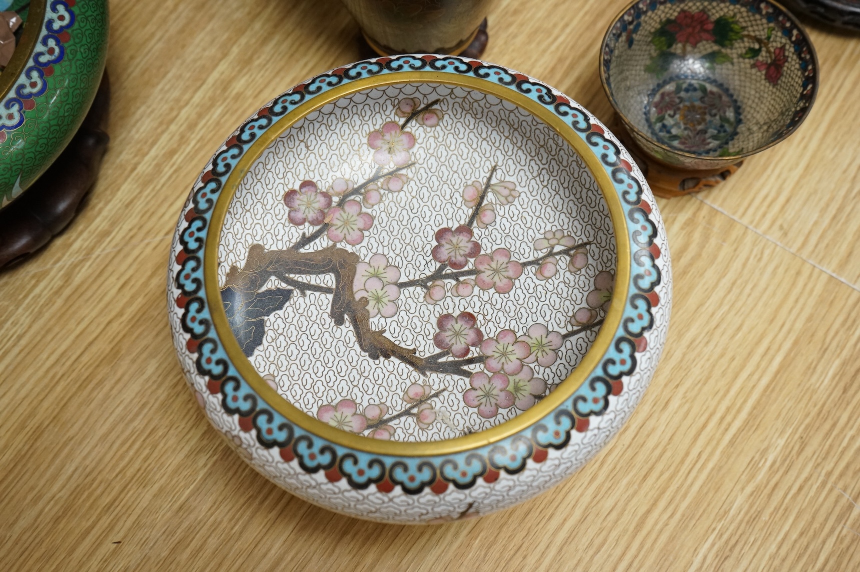 A plique a jour enamel tea bowl together with a collection of cloisonné enamel vases, bowls etc., tallest 26cm